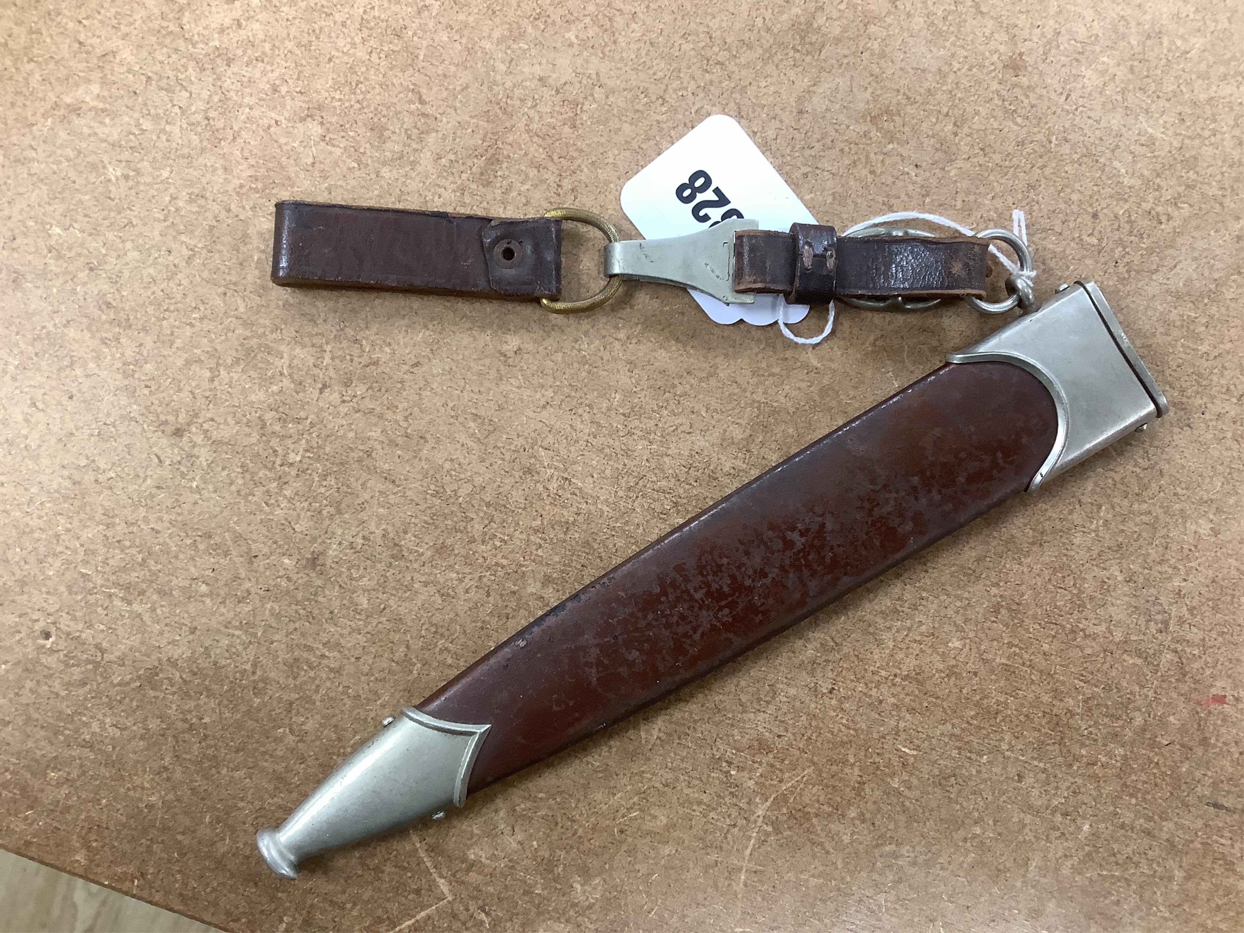 A WWII German SA dagger, regulation pattern in its steel scabbard with regulation nickel mounts, and leather hanging band and a German dress bayonet by Paul Seilheimer. Condition - fair, some wear